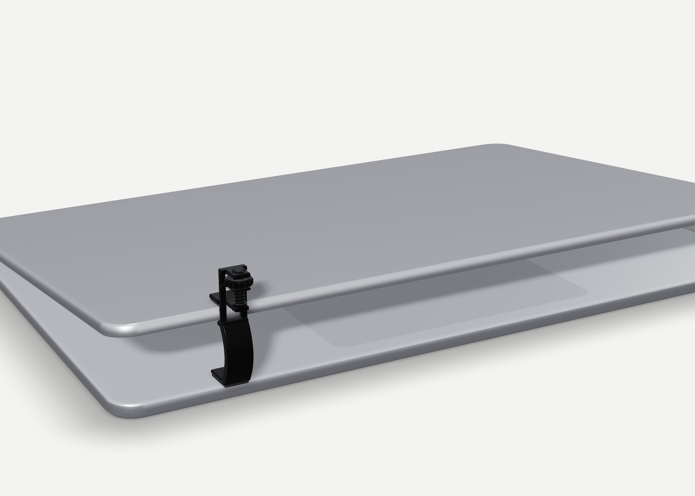 A silver laptop held slightly open by the black Propt Clip at its front edge